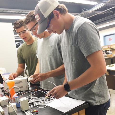 David Leonardo, Christopher Szigeti, and Zachary Kisner at work on a soft robotic hand image link to story