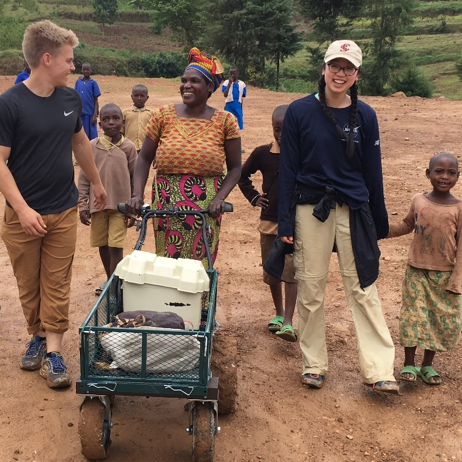 Students collaborating with women in Rwanda