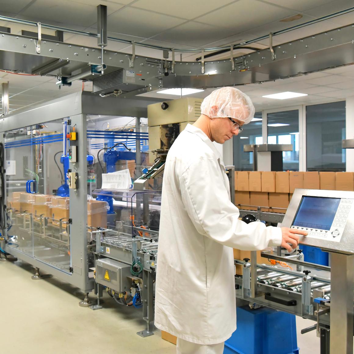 Worker in biopharmaceutical manufacturing plant at a computer image link to story