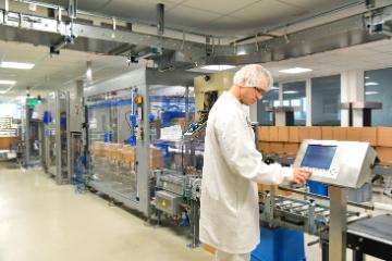 Worker in biopharmaceutical manufacturing plant at a computer