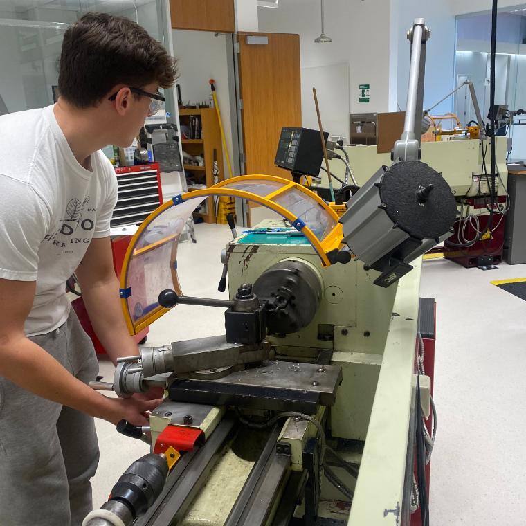 A photo of a student with the Robotic Arm Extrusion End Effector image link to story
