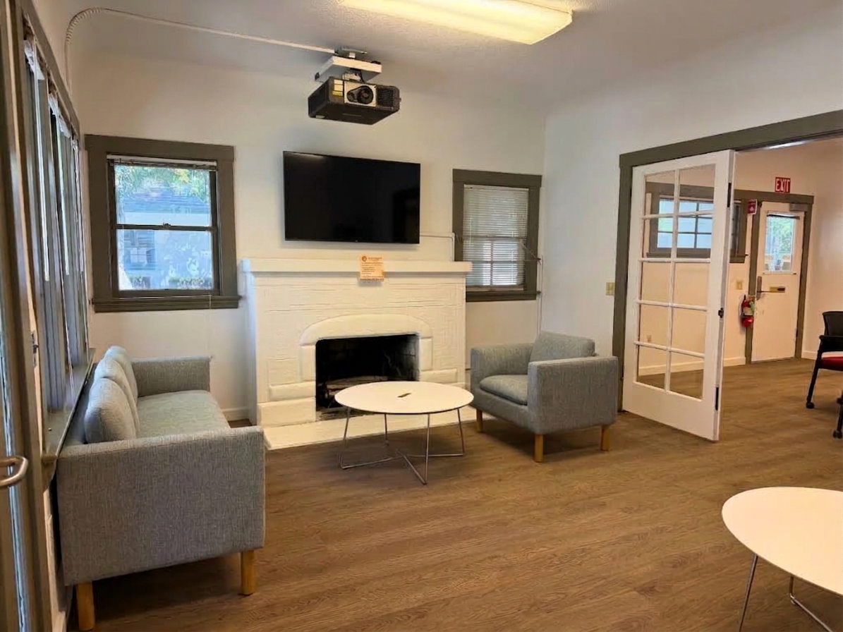 Grad hub living room with a couch and TV and a coffee table and a chair to lounge in 