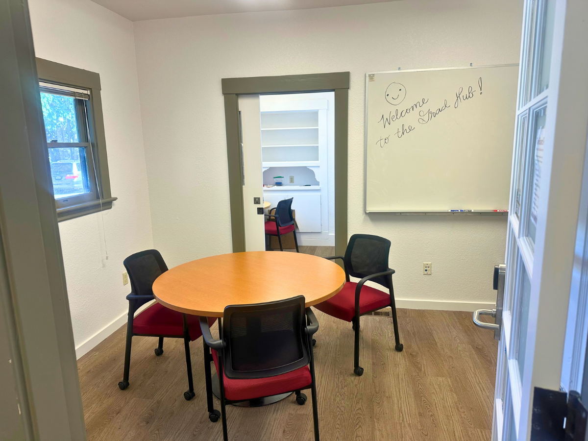 Board room with a small table, chairs, and a white board 