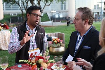 Two men talking at Demo Day 2025 event