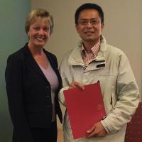 Gangshu Cai receiving the 2016 Leavey Impact Award for Service