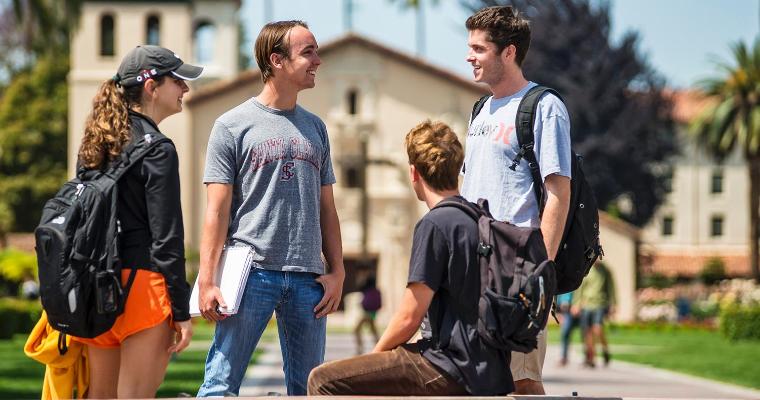 SCU students talking around a campus fountain.