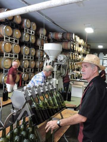 George E. Guglielmo fills wine bottles at Guglielmo Winery's 45th Cork Equity.  image link to story