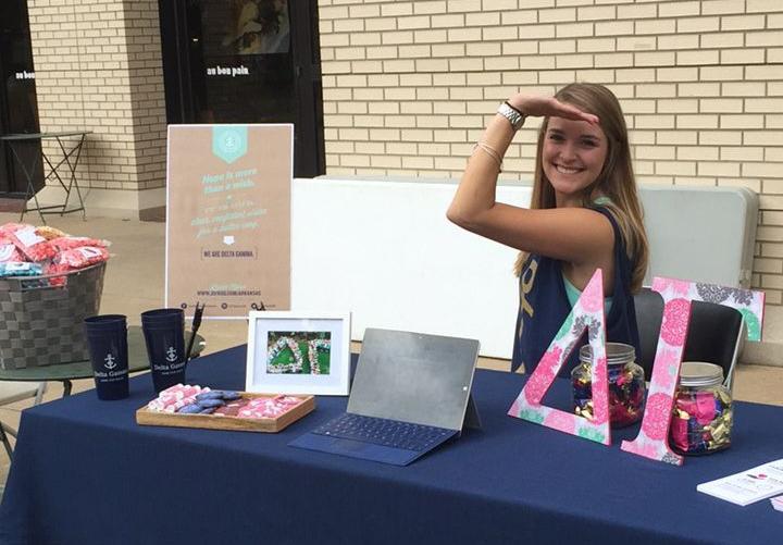Allison Byrne at the Delta Gamma table at the University of Arkansas. image link to story