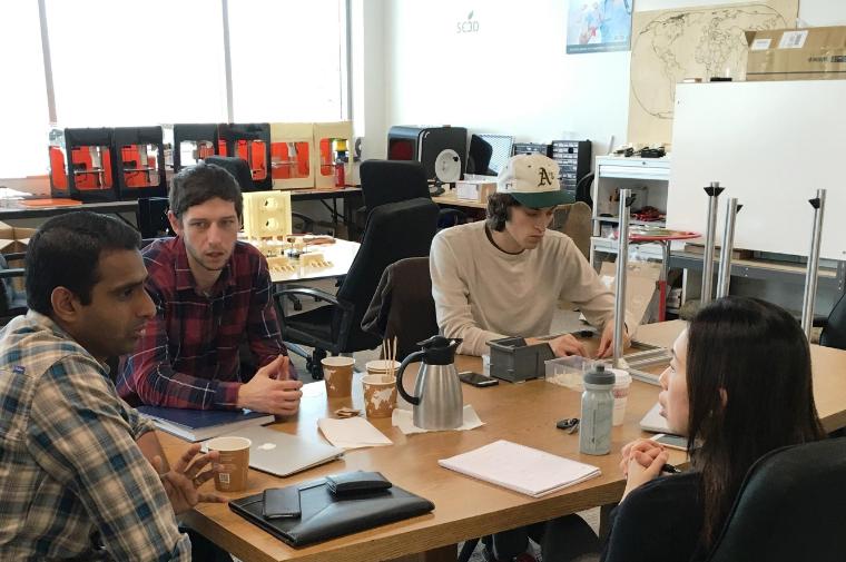 Prashanth Asuri (left) collaborating with SE3D co-founder Mayasari Lim and Kevin Kozel ’14, MS ’16 and Theron Hawley ’14. Production of the 3D bioprinters, seen in the background, is taking place in the EdVenture incubation space at SCU. Credit: Heidi Williams