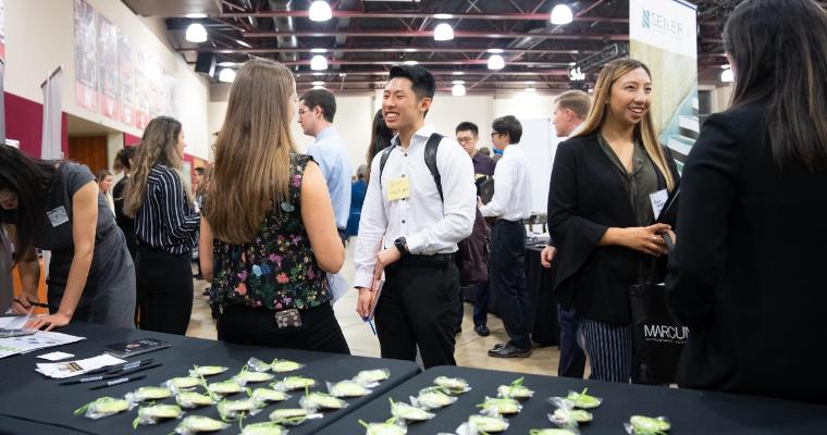 Students talking with firm reps at the annual Meet the Firms event. image link to story