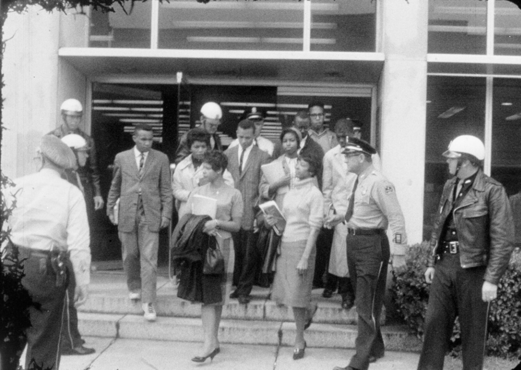 The Tougaloo Nine are escorted from the  Jackson Public Library in 1961