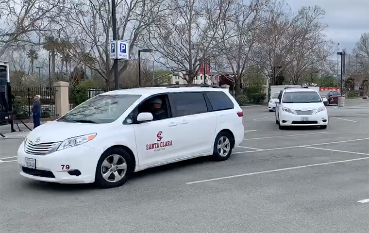 Santa Clara University Athletics vans drive across parking lot image link to story